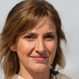 Joyful white adult female with medium  brown hair and grey eyes