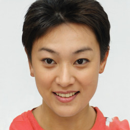 Joyful asian young-adult female with short  brown hair and brown eyes