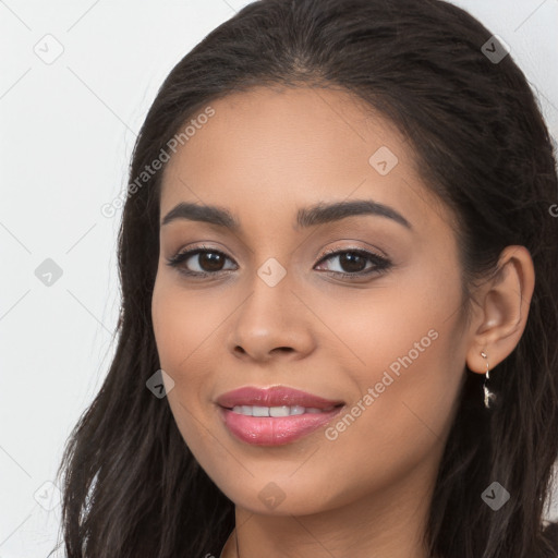 Joyful latino young-adult female with long  brown hair and brown eyes