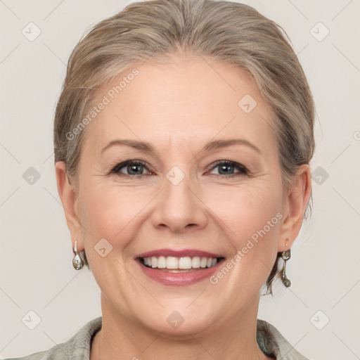 Joyful white adult female with medium  brown hair and grey eyes