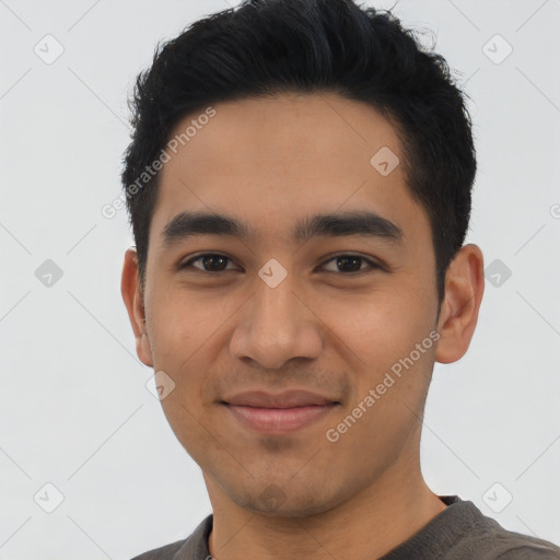 Joyful latino young-adult male with short  black hair and brown eyes