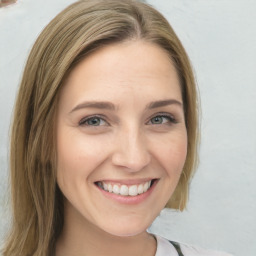 Joyful white young-adult female with medium  brown hair and blue eyes