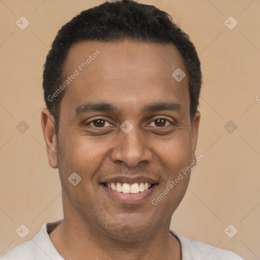 Joyful latino young-adult male with short  brown hair and brown eyes