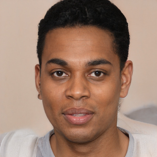 Joyful black young-adult male with short  black hair and brown eyes