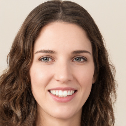 Joyful white young-adult female with long  brown hair and green eyes