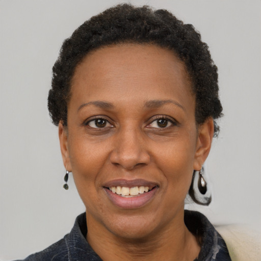 Joyful black adult female with short  brown hair and brown eyes