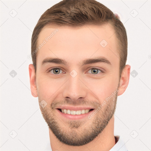 Joyful white young-adult male with short  brown hair and grey eyes