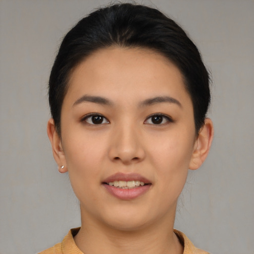 Joyful asian young-adult female with short  brown hair and brown eyes