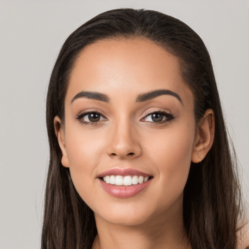 Joyful white young-adult female with long  brown hair and brown eyes