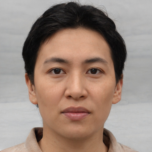 Joyful asian young-adult female with short  brown hair and brown eyes