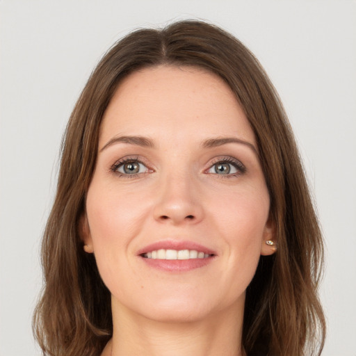 Joyful white young-adult female with long  brown hair and green eyes