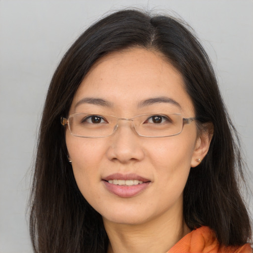 Joyful white adult female with long  brown hair and brown eyes