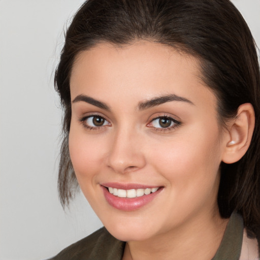 Joyful white young-adult female with medium  brown hair and brown eyes