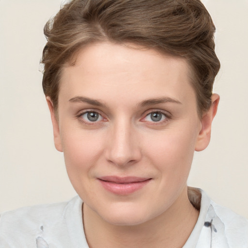 Joyful white young-adult female with short  brown hair and grey eyes