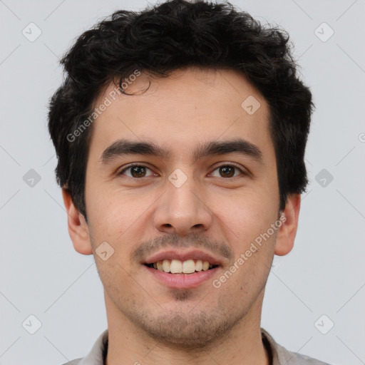 Joyful latino young-adult male with short  brown hair and brown eyes