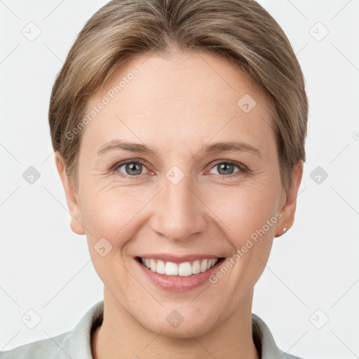 Joyful white adult female with short  brown hair and grey eyes