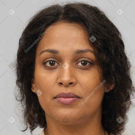 Joyful black young-adult female with long  brown hair and brown eyes