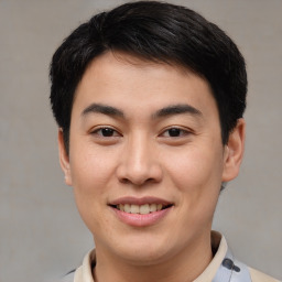 Joyful asian young-adult male with short  brown hair and brown eyes