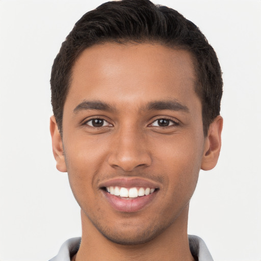 Joyful black young-adult male with short  brown hair and brown eyes