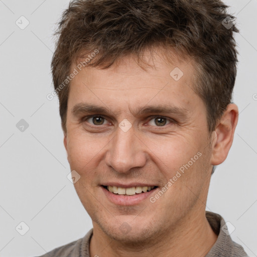 Joyful white adult male with short  brown hair and brown eyes