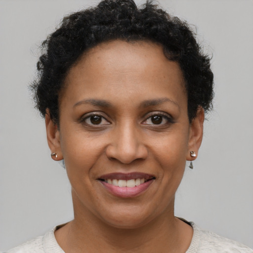 Joyful black young-adult female with short  brown hair and brown eyes