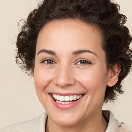 Joyful white young-adult female with medium  brown hair and brown eyes