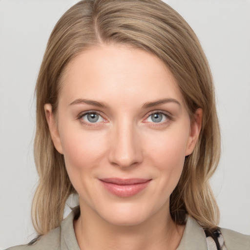 Joyful white young-adult female with medium  brown hair and blue eyes