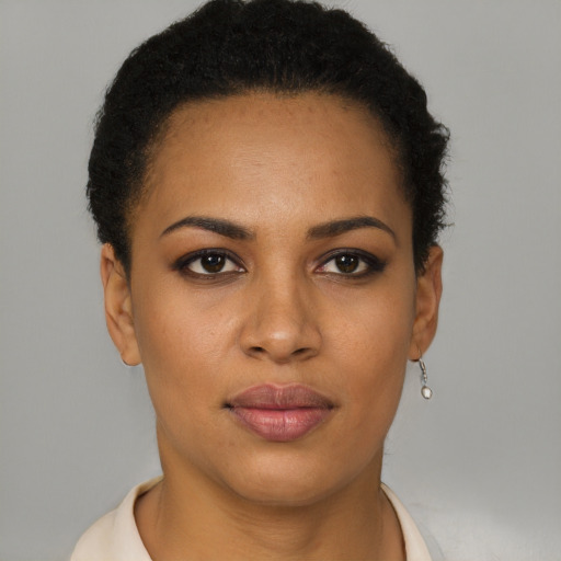 Joyful latino young-adult female with short  brown hair and brown eyes
