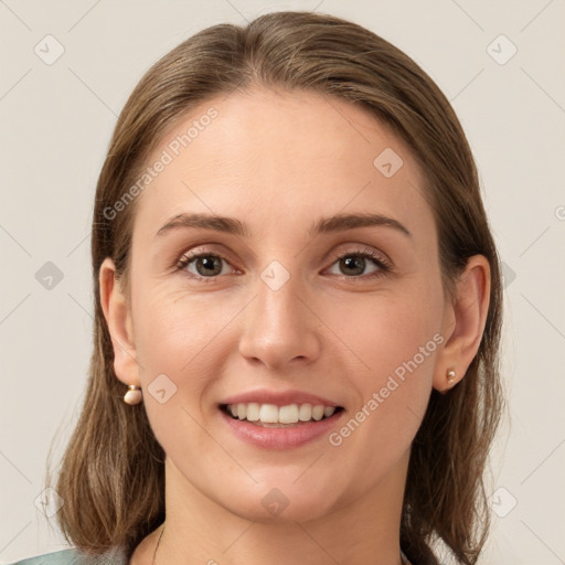 Joyful white young-adult female with medium  brown hair and grey eyes