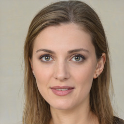 Joyful white young-adult female with long  brown hair and green eyes