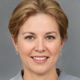 Joyful white adult female with medium  brown hair and grey eyes