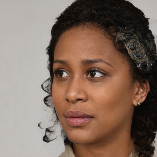 Neutral black young-adult female with medium  black hair and brown eyes
