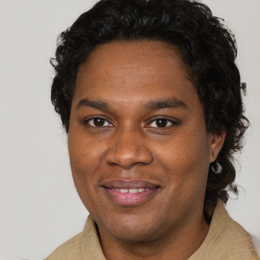 Joyful black young-adult male with short  brown hair and brown eyes