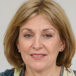 Joyful white adult female with medium  brown hair and blue eyes