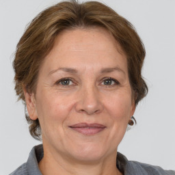 Joyful white adult female with medium  brown hair and grey eyes