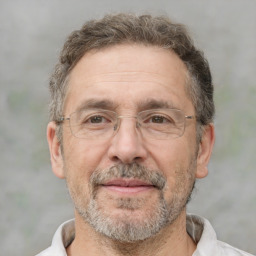 Joyful white middle-aged male with short  brown hair and brown eyes