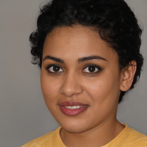 Joyful latino young-adult female with short  brown hair and brown eyes