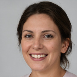 Joyful white adult female with medium  brown hair and brown eyes