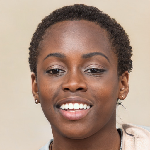 Joyful black young-adult female with short  brown hair and brown eyes