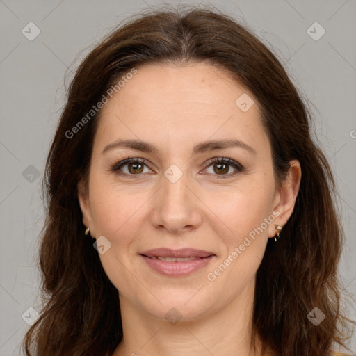 Joyful white adult female with long  brown hair and brown eyes