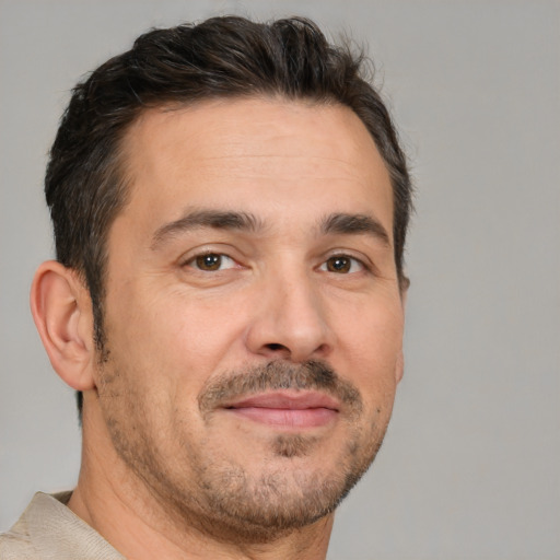 Joyful white adult male with short  brown hair and brown eyes