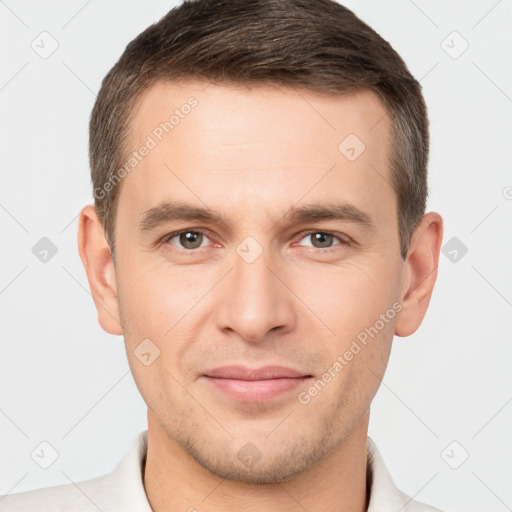 Joyful white young-adult male with short  brown hair and brown eyes