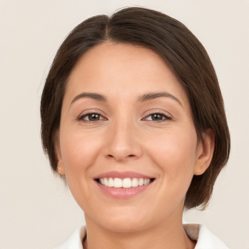 Joyful white young-adult female with medium  brown hair and brown eyes