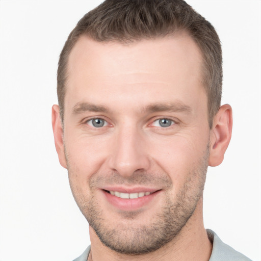 Joyful white young-adult male with short  brown hair and grey eyes