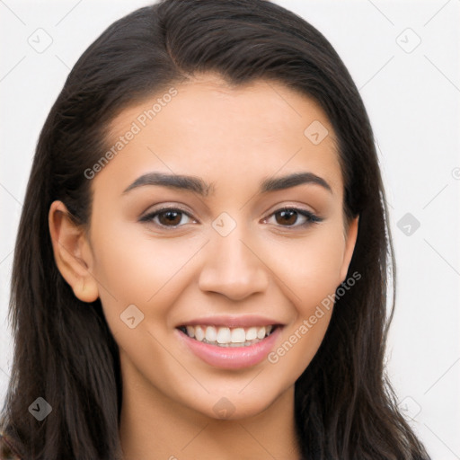 Joyful latino young-adult female with long  brown hair and brown eyes