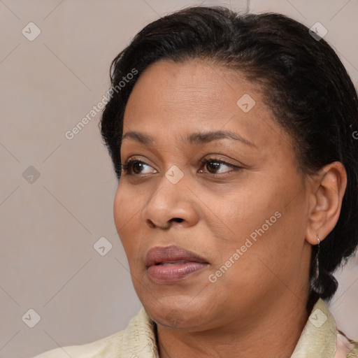 Joyful latino adult female with medium  brown hair and brown eyes