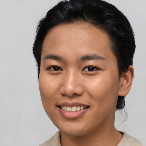 Joyful asian young-adult female with short  brown hair and brown eyes