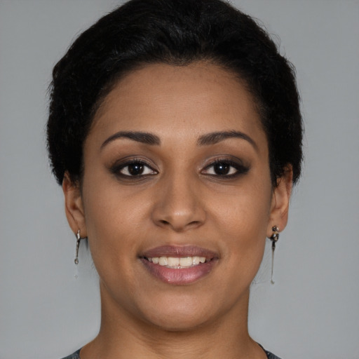 Joyful latino young-adult female with short  brown hair and brown eyes