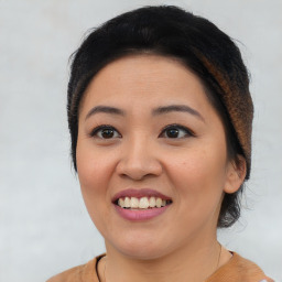 Joyful asian young-adult female with short  brown hair and brown eyes