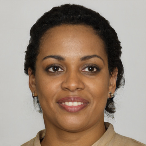 Joyful latino young-adult female with short  black hair and brown eyes
